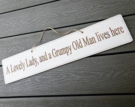 A lovely lady, and a grumpy old man lives here Sign